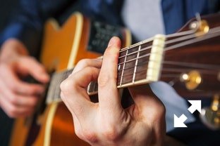 Singer Songwriter playing acoustic guitar